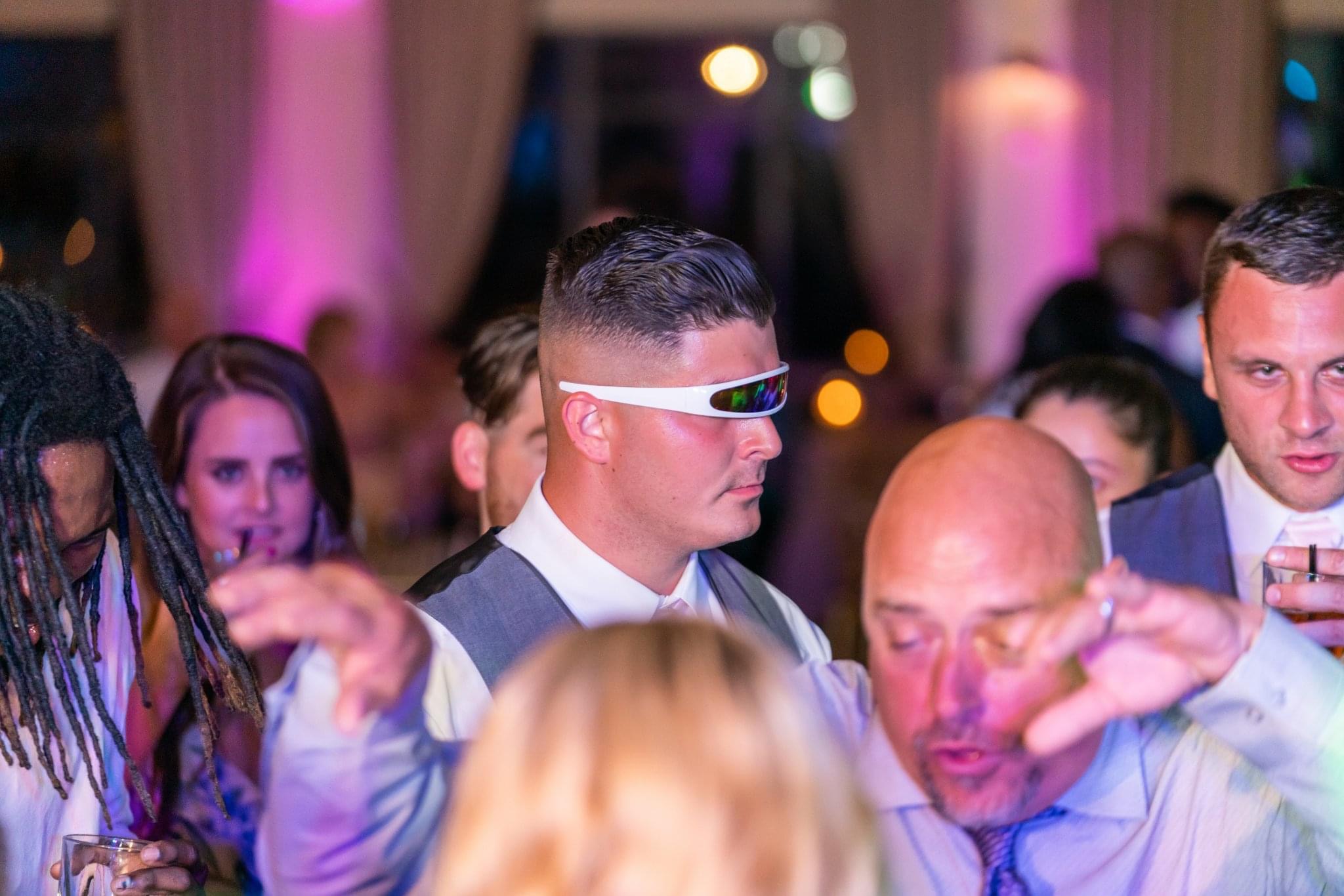 Guests dancing at wedding with full dance floor and lights